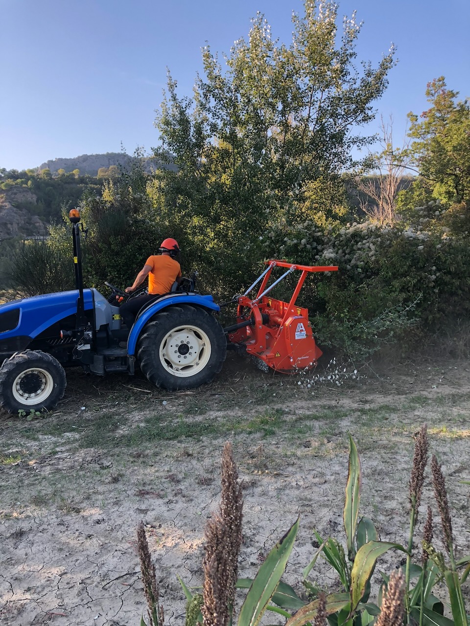 Tracteur équipé d’un broyeur en intervention devant une végétation dense